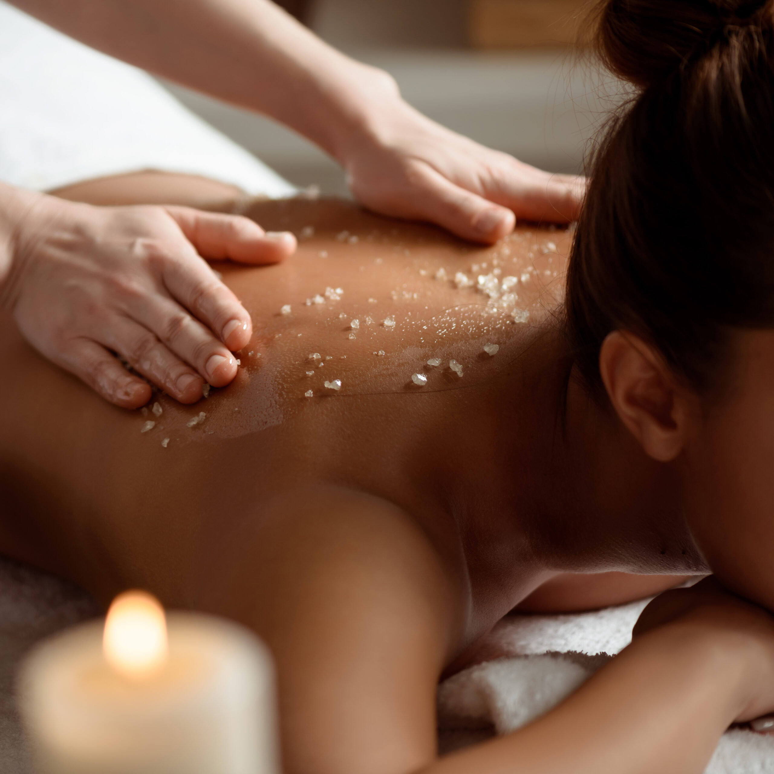 Young beautiful brunette girl relaxing in spa salon. Copy space.
